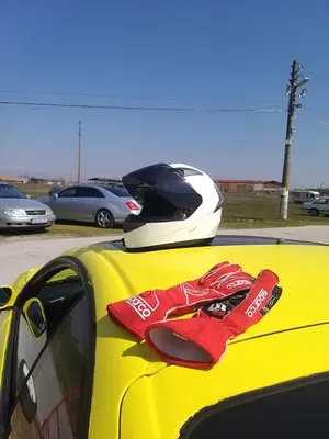 a pair of red gloves sitting on the hood of a car at вила Топи in Kaloyanovo