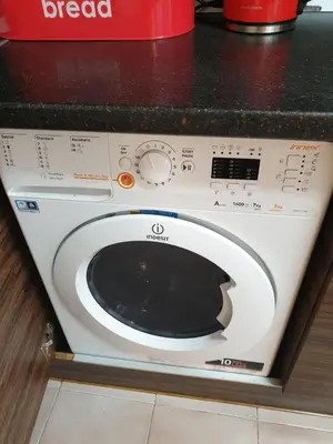 a white washing machine sitting on top of a counter at Apartment Lozenets in Sofia