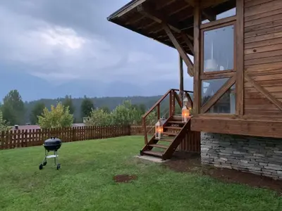 a grill in a yard next to a house at Katarino Mountain House in Razlog