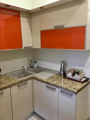 a kitchen with orange and white cabinets and a sink at Luxury Villa Borina in Zheleznitsa