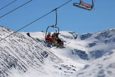 three people on a ski lift on a snowy mountain at VALENTINA`S STUDIO in 