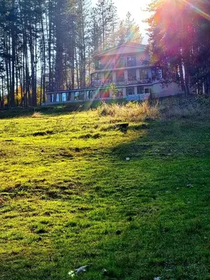 a house on a hill with a field of grass at Вила АРБОРЕТУМ - онлайн self check-in in Teteven