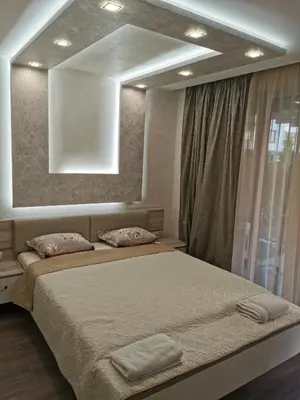 a bedroom with a large bed with a large mirror at Paradise Swing Apartment Sofia in Sofia