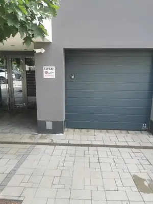 a blue garage door with a sign on it at Paradise Swing Apartment Sofia in Sofia