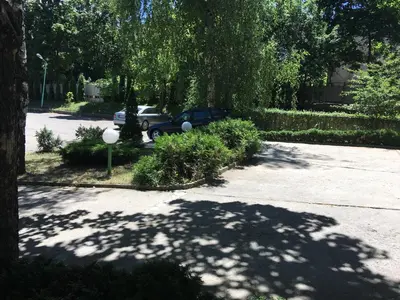 a parking lot with a car parked in a driveway at Hostel Elena in Sofia