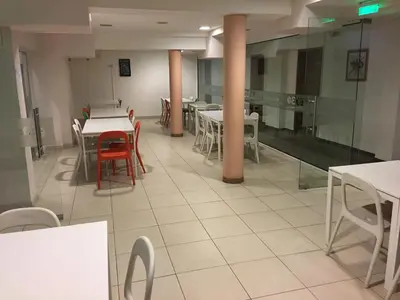 a dining room with tables and chairs in a restaurant at Hostel Elena in Sofia