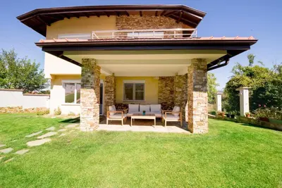 a house with a patio with a roof at Villa Detelina in Sapareva Banya