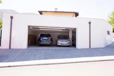 a white garage with two cars in it at Villa Detelina in Sapareva Banya