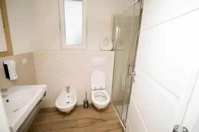 a bathroom with a toilet and a sink at Villa Detelina in Sapareva Banya