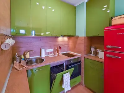 a kitchen with green cabinets and a red refrigerator at Gondola 1 BDRM Flat in Cedar Lodge IV (D2) in Bansko