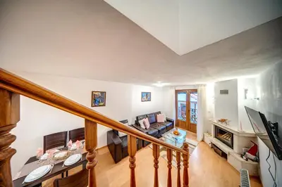 a view of a living room from the stairs at MyPlace Pamporovo апартаменти за отдих in Pamporovo
