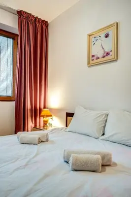 a bed with two towels on top of it at MyPlace Pamporovo апартаменти за отдих in Pamporovo