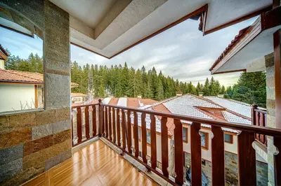a balcony with a view of the mountains at MyPlace Pamporovo апартаменти за отдих in Pamporovo