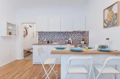 a kitchen with a table and chairs in a room at Cosy & renovated 2BD flat near Vitoshka by Flat Mаnager in Sofia