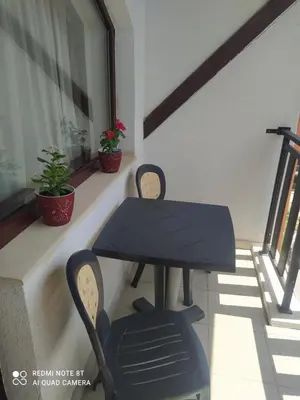 a black table and chairs on a balcony at Апартамент С-59 в Апарт-хотел Боровец Гардънс in Borovets
