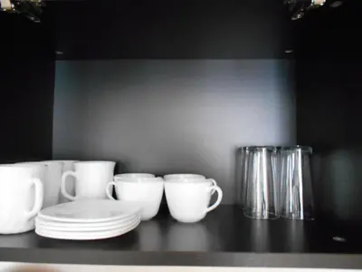 a counter with white cups and plates on it at Апартамент С-59 в Апарт-хотел Боровец Гардънс in Borovets