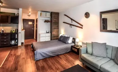 a living room with a bed and a couch at Bansko Royal Towers Apartments - Gondola View in Bansko