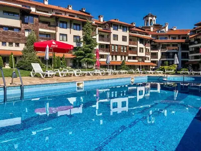 a large swimming pool in front of a hotel at Bansko Royal Towers Apartments - Gondola View in Bansko