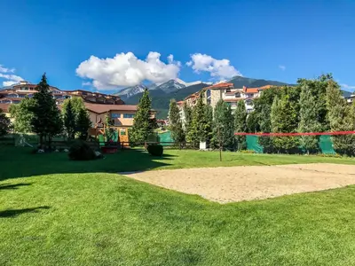 a park with a volley ball hoop in the grass at Bansko Royal Towers Apartments - Gondola View in Bansko