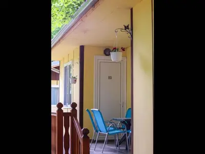 a dining room with blue chairs and a table at Nice bungalow in Petrich in Kamena