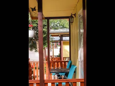 a porch with a table and chairs on a balcony at Nice bungalow in Petrich in Kamena