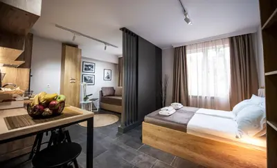 a bedroom with a bed and a table with a bowl of fruit at Borovete Mountain Luxury in Borovets
