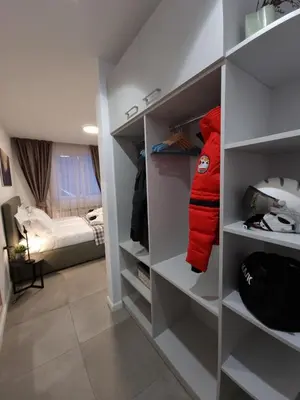 a walk in closet with a red jacket in it at Borovete Mountain Luxury in Borovets