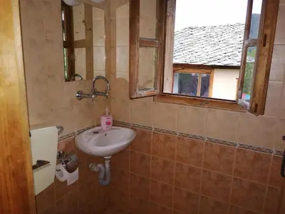 a bathroom with a sink and a window at Къща за гости Кануш войвода in Kovachevitsa
