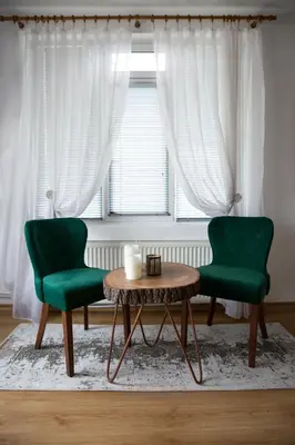 two green chairs and a table in front of a window at къща Слави in Oreshak