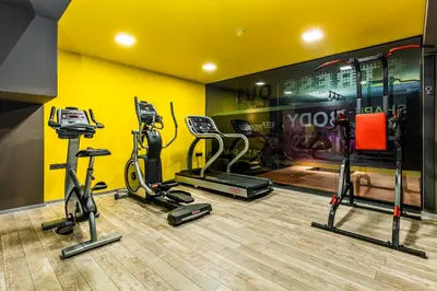 a gym with treadmills and exercise bikes in a room at Hotel Urban in Plovdiv