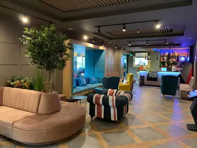 a lobby with couches and chairs and a living room at Hotel Urban in Plovdiv