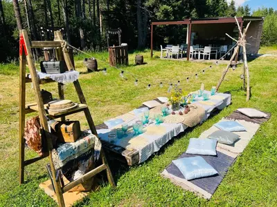 a table with vases on it in the grass at Zarevo Glamping in Skobelevo
