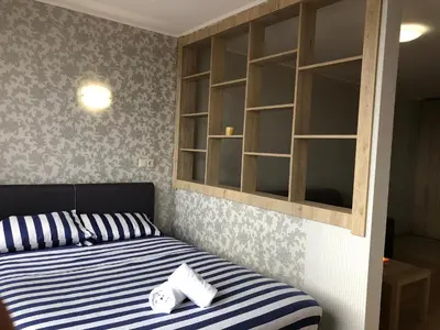 a bedroom with a bed with blue and white stripes at Aspen heights studio 308 in Razlog