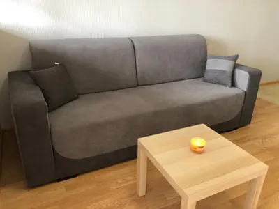 a grey couch in a living room with a coffee table at Aspen heights studio 308 in Razlog