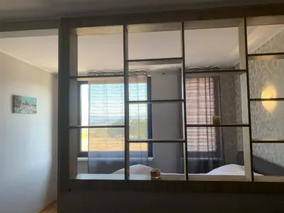 a mirror in a room with a bed and a window at Aspen heights studio 308 in Razlog