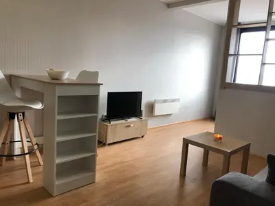 a living room with a tv and a table at Aspen heights studio 308 in Razlog
