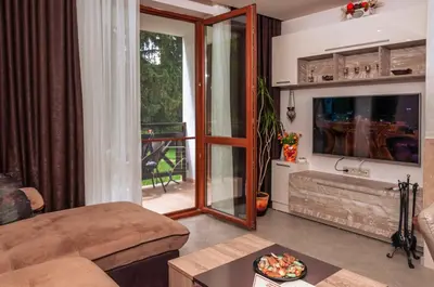 a living room with a large mirror and a television at Луксозен апартамент - 