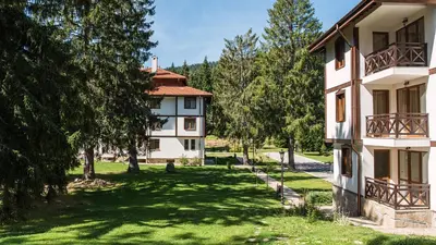 an apartment building with a yard with trees at Луксозен апартамент - 