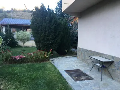 a bench sitting next to a house with a yard at Willy Villy`s house in Chepelare