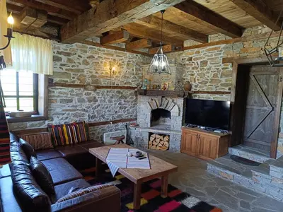 a living room with a couch and a fireplace at LITTLE BIRD Residency - Luxury Guesthouses in Leshten in Leshten