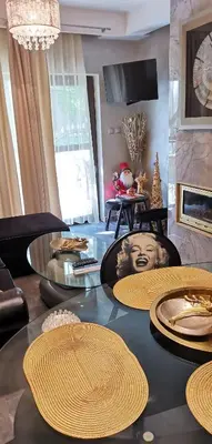 a living room with a table with plates on it at Мирков Дар in Bansko