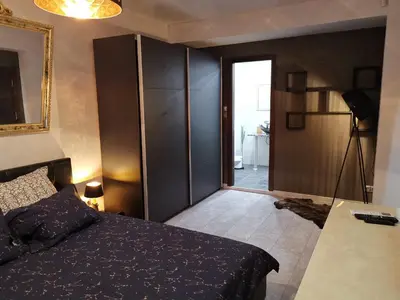 a bedroom with a bed and a sliding glass door at Мирков Дар in Bansko