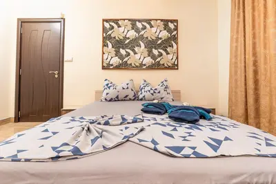 a bed with blue and white sheets and pillows at 1BD apartment in a calm area near the centre by Flat Mаnager in Plovdiv