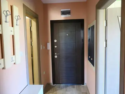 a hallway with a black door in a room at Nikol Deluxe in Velingrad