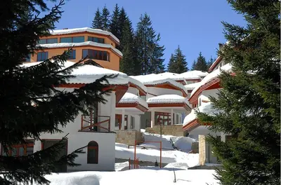 a building with snow on the roof of it at 2 bedroom, 2 showeroom Villa suitable for a family skication and remote working in Pamporovo