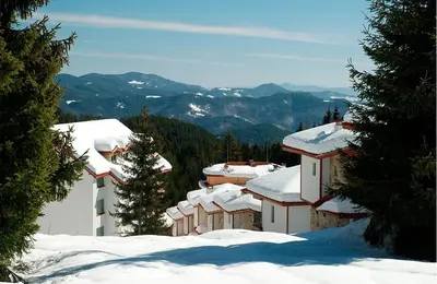 a group of buildings with snow on the roofs at 2 bedroom, 2 showeroom Villa suitable for a family skication and remote working in Pamporovo