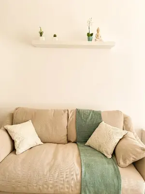 a couch with two pillows on top of it at Pirin Golf Studio Apartment in Razlog