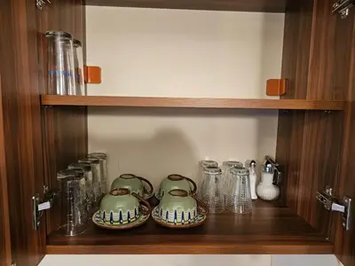 a wooden shelf with three tea pots and glassutes at Емили Фемили Хаус in Koprivshtitsa