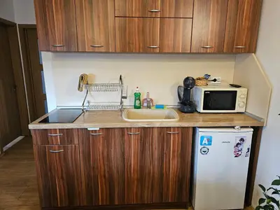 a small kitchen with a microwave and a refrigerator at Емили Фемили Хаус in Koprivshtitsa