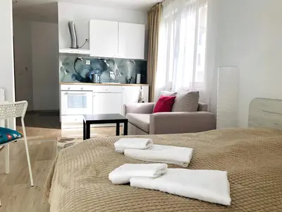 a bedroom with a bed with towels on it at Temerso Studio-Apartment in Bansko
